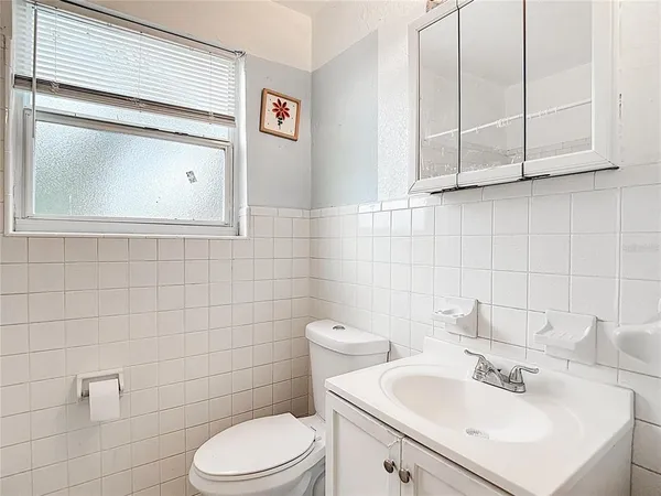 a bathroom with a sink a toilet and mirror