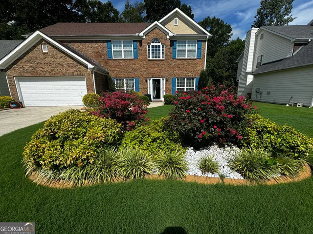 a front view of a house with a garden
