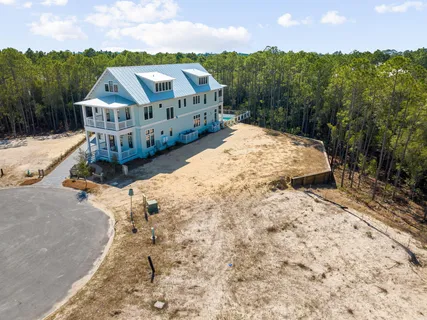 a view of a house with wooden fence