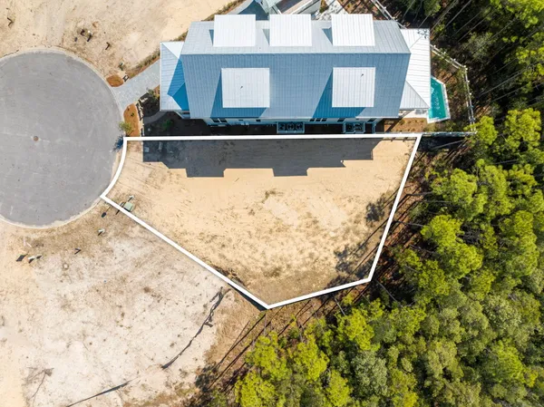an aerial view of a house with swimming pool