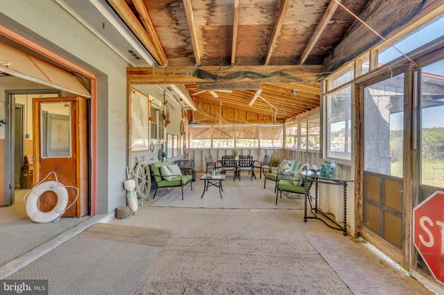 a view of a livingroom with furniture and a window