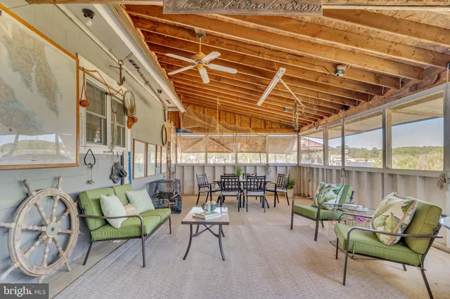 a view of a chairs and table in the patio and a wooden roof