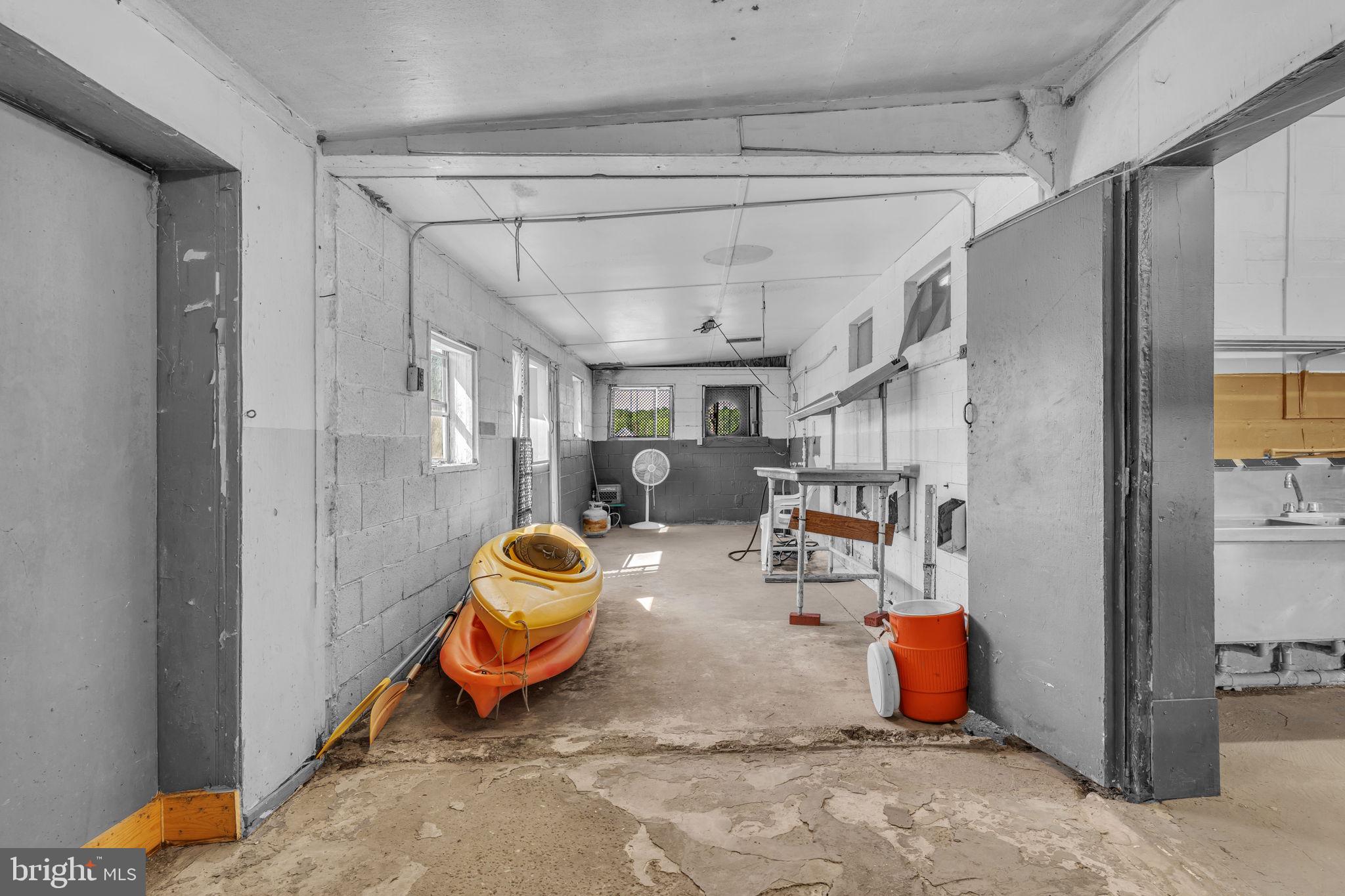 16129 Piney Point Road Piney Point, MD 20674 - Photo 29 of 50 a living room filled with furniture and gym equipment
