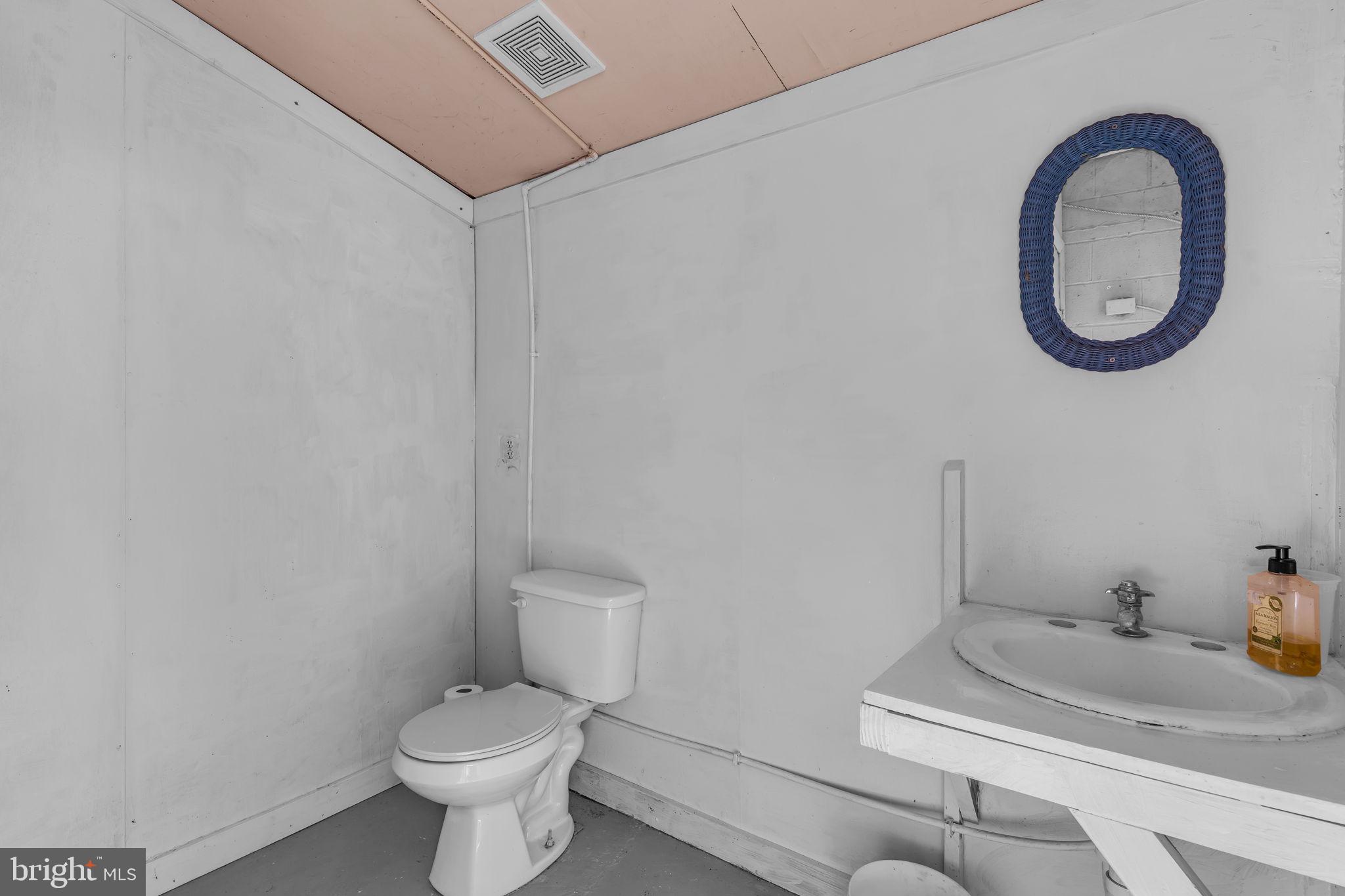 16129 Piney Point Road Piney Point, MD 20674 - Photo 35 of 50 a bathroom with a sink and a toilet