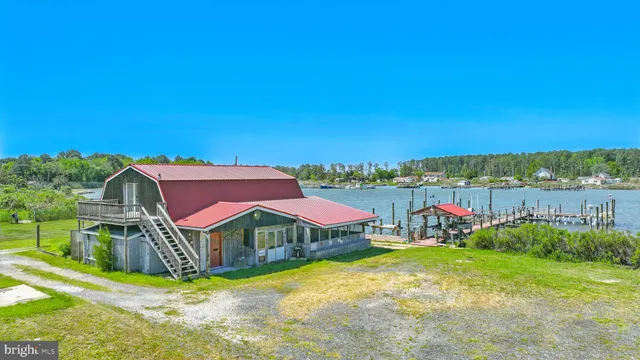 a view of a house with a yard and sitting area