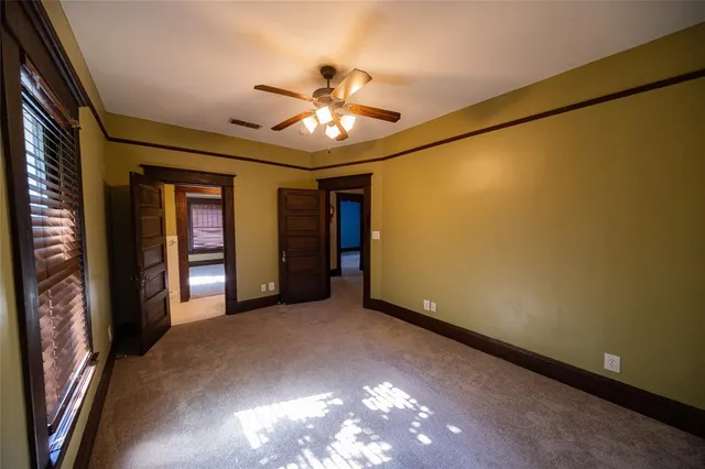 a view of an empty room with a ceiling fan