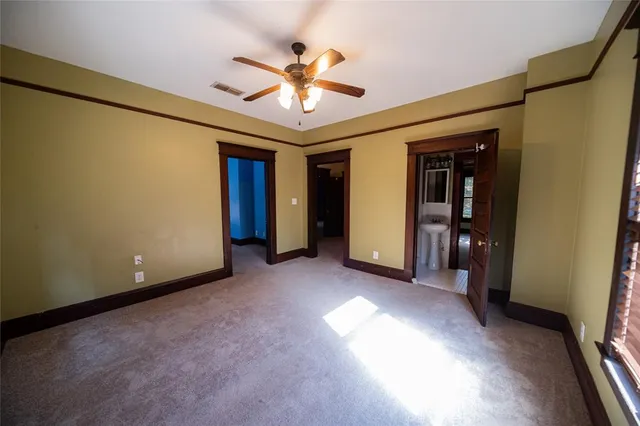 a view of a livingroom with a ceiling fan and window