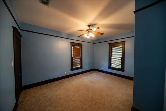 a view of an empty room with windows