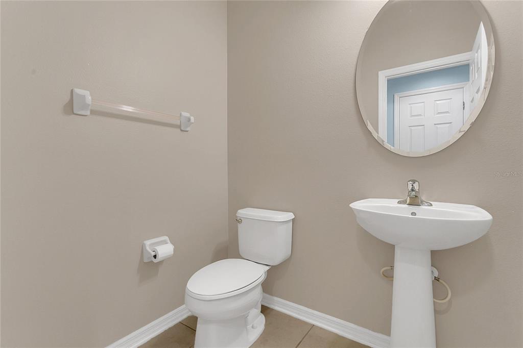 543 Rainbow Springs Loop Groveland, FL 34736 - Photo 11 of 26 a bathroom with a toilet sink and mirror