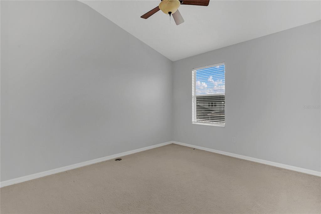 543 Rainbow Springs Loop Groveland, FL 34736 - Photo 18 of 26 an empty room with a ceiling fan and window
