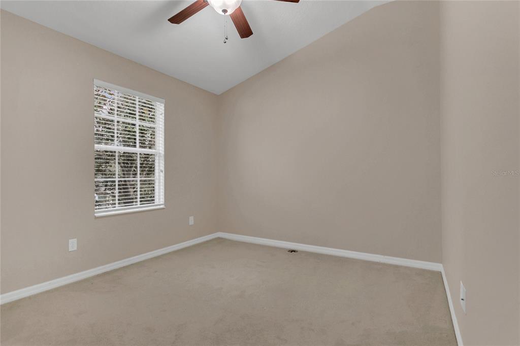 543 Rainbow Springs Loop Groveland, FL 34736 - Photo 19 of 26 an empty room with a window and a fan
