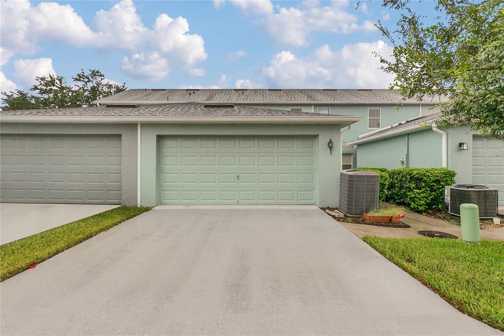 543 Rainbow Springs Loop Groveland, FL 34736 - Photo 23 of 26 a front view of a house with a yard and garage