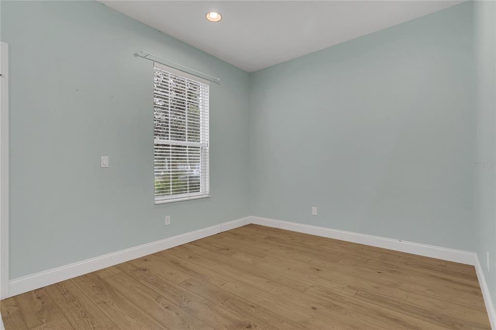 543 Rainbow Springs Loop Groveland, FL 34736 - Photo 8 of 26 wooden floor in an empty room with a window