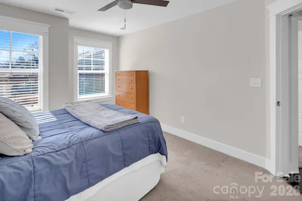 a view of a hallway with wooden floor and closet