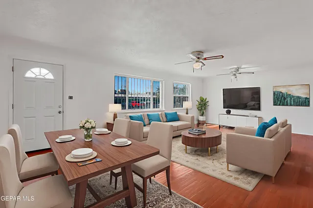 a living room with furniture a rug and a flat screen tv