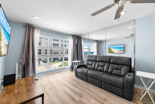 a living room with furniture and a floor to ceiling window