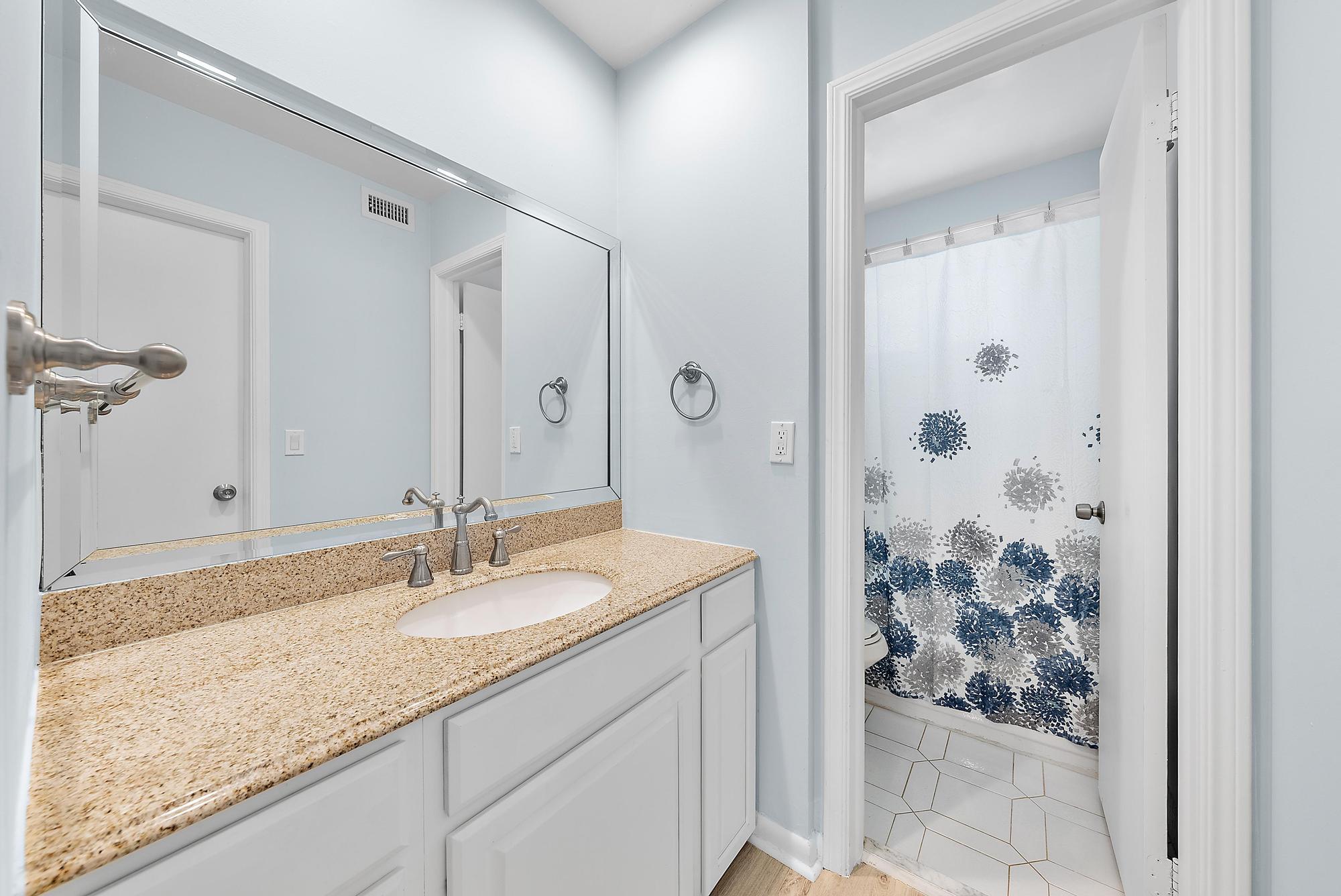 3851 North Ocean Boulevard, Unit 202 Gulf Stream, FL 33483 - Photo 13 of 20 a bathroom with a granite countertop sink and a mirror