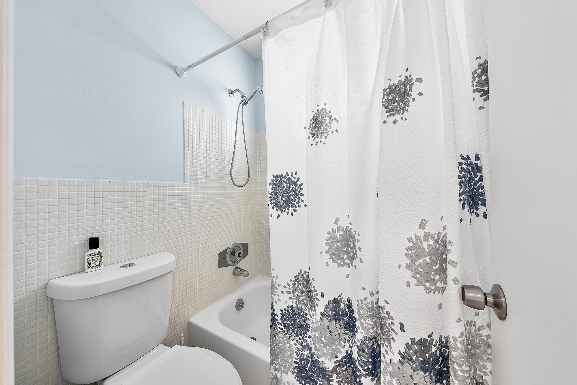 3851 North Ocean Boulevard, Unit 202 Gulf Stream, FL 33483 - Photo 14 of 20 a bathroom with a toilet sink and shower curtain