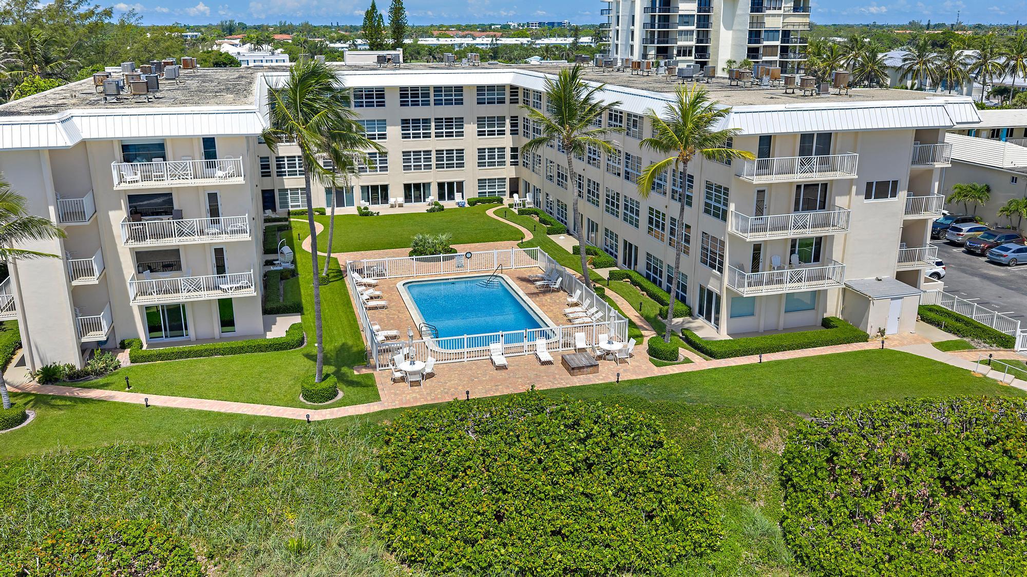 3851 North Ocean Boulevard, Unit 202 Gulf Stream, FL 33483 - Photo 2 of 20 an aerial view of an apartment building with a yard