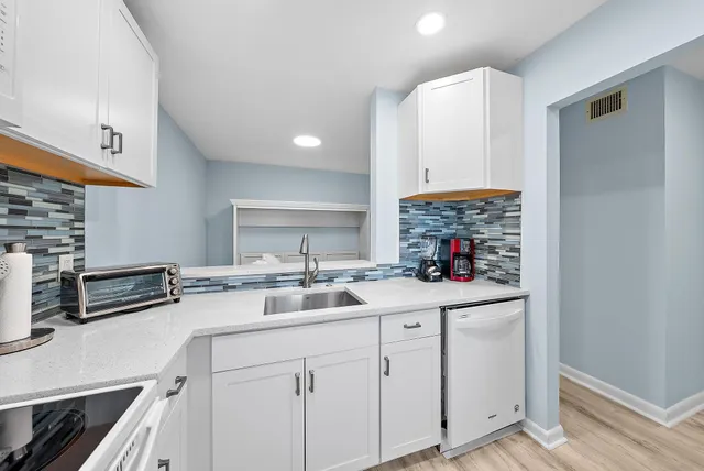 a kitchen with a sink stove and cabinets