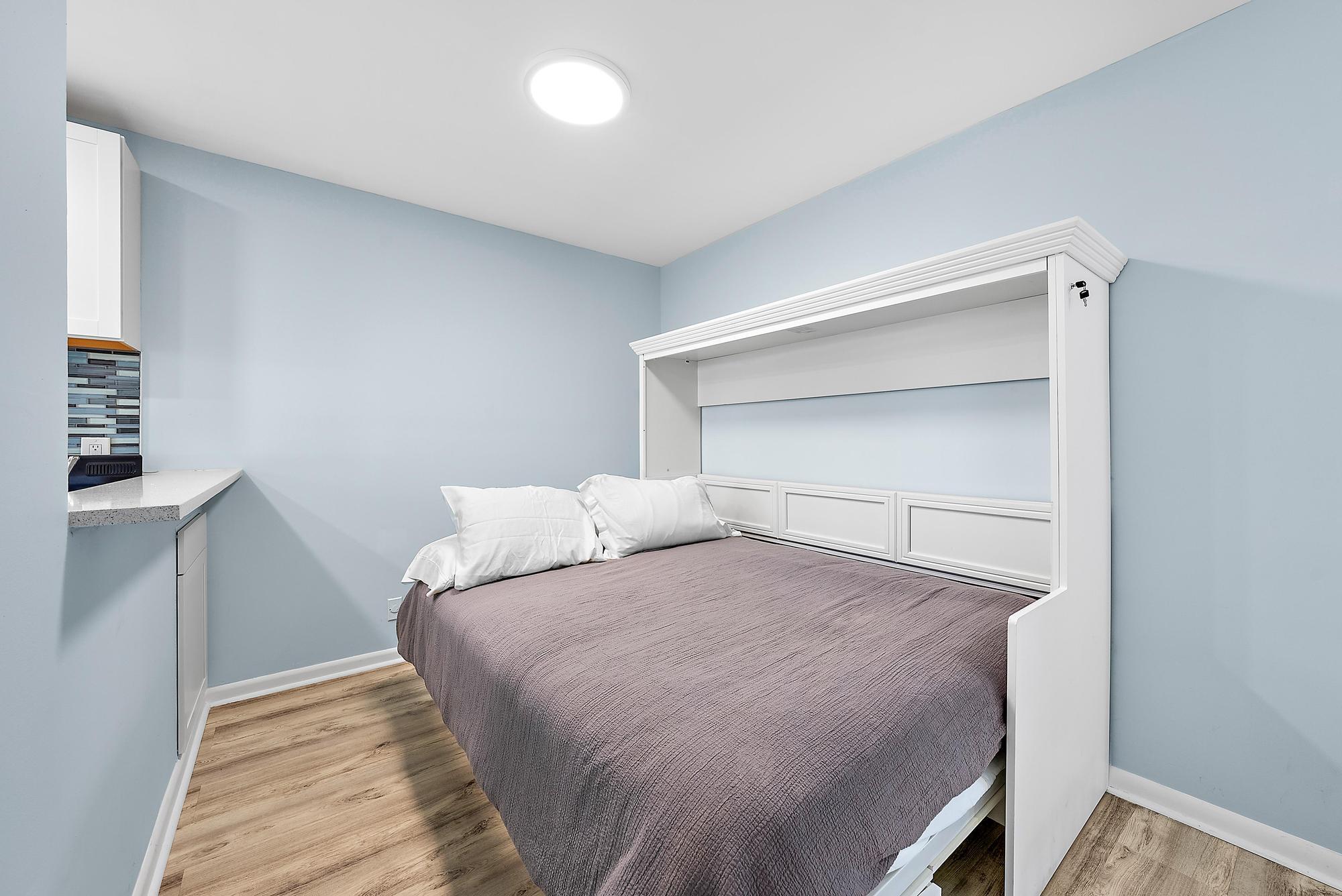 3851 North Ocean Boulevard, Unit 202 Gulf Stream, FL 33483 - Photo 8 of 20 a bedroom with a bed and utility room