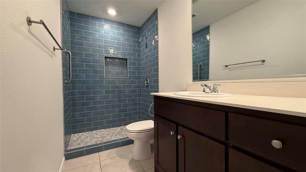 14065 Haggerston Drive Pilot Point, TX 76258 - Photo 14 of 21 a bathroom with a sink a toilet and shower
