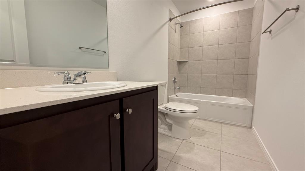 14065 Haggerston Drive Pilot Point, TX 76258 - Photo 15 of 21 a bathroom with a sink a toilet and shower