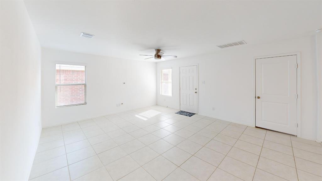 14065 Haggerston Drive Pilot Point, TX 76258 - Photo 3 of 21 an empty room with chandelier fan and windows