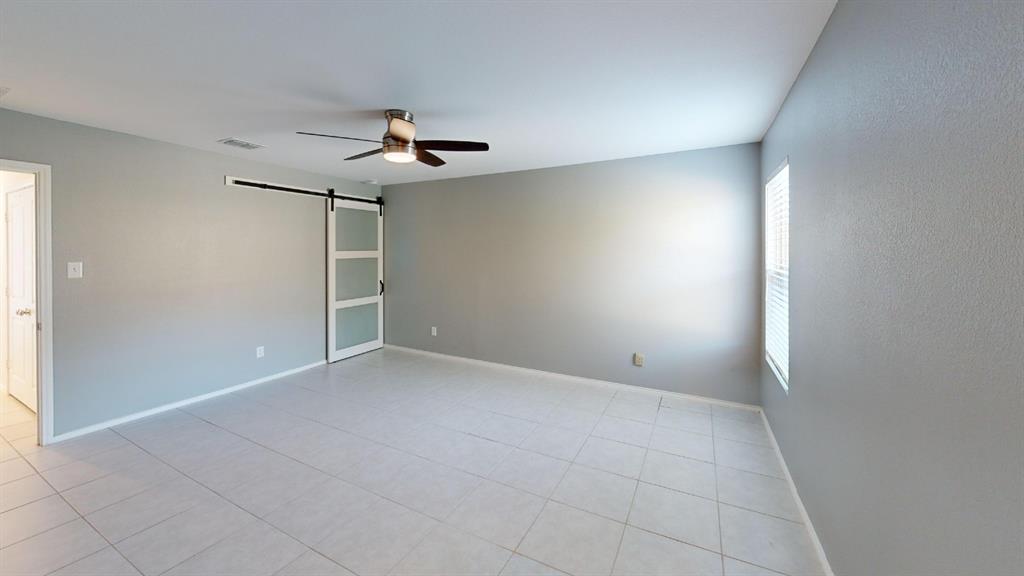 14065 Haggerston Drive Pilot Point, TX 76258 - Photo 7 of 21 an empty room with a window and a ceiling fan