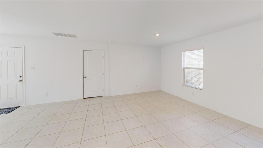 14065 Haggerston Drive Pilot Point, TX 76258 - Photo 8 of 21 an empty room with white walls and windows