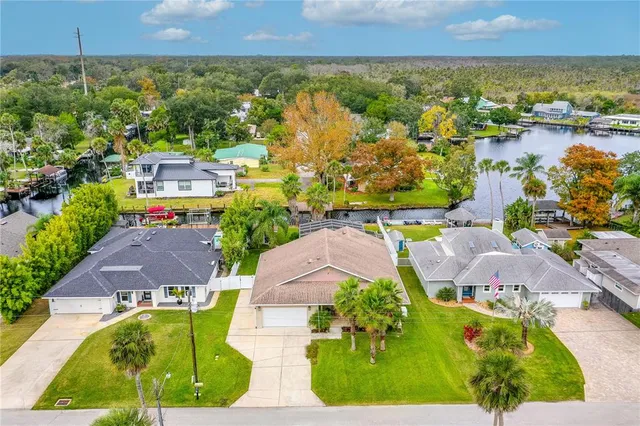 an aerial view of residential houses with outdoor space and swimming pool