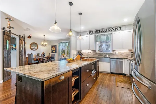 a kitchen with granite countertop white cabinets and white appliances