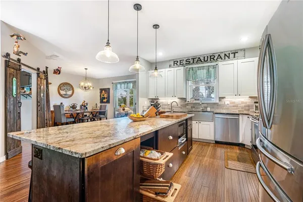 a kitchen with stainless steel appliances granite countertop a stove and a refrigerator
