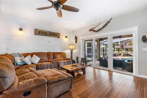 a living room with furniture and a wooden floor