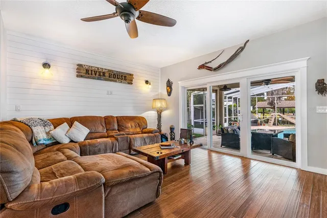 a living room with furniture and a wooden floor