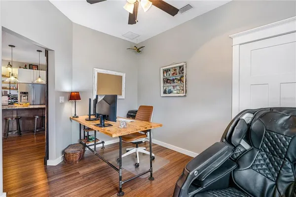 a bedroom with a bed and a wooden floor
