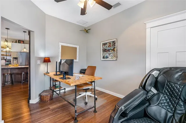 a bedroom with a bed and a wooden floor