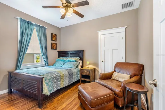 a spacious bathroom with a toilet a double vanity sink a mirror and a shower