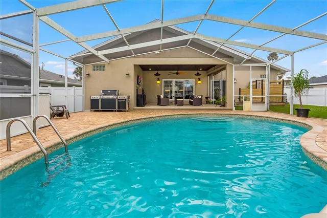a swimming pool with patio outdoor seating and yard