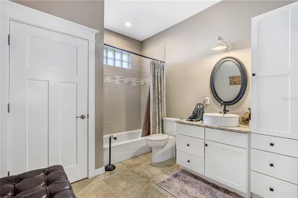 a living room with furniture a flat screen tv and a table