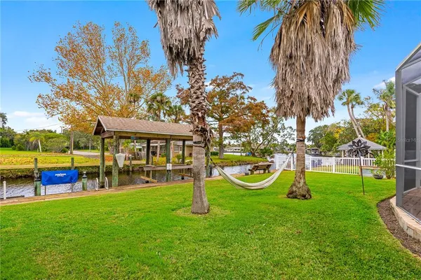 a view of a house with backyard and a patio
