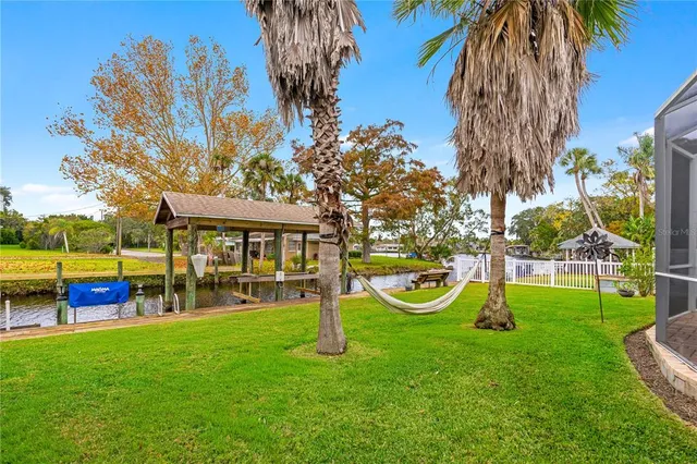 a view of a house with backyard and a patio