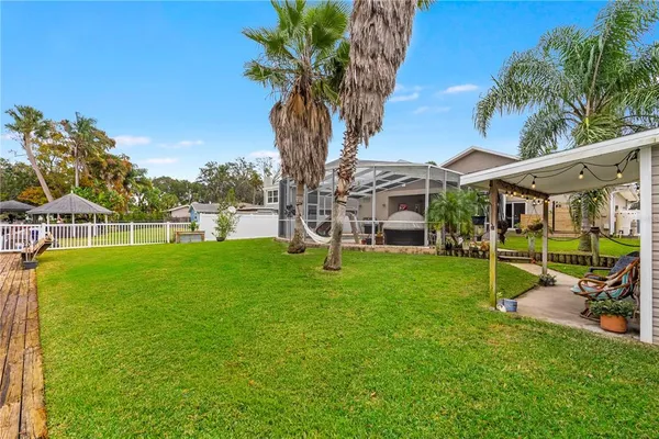 a view of a house with pool and sitting area