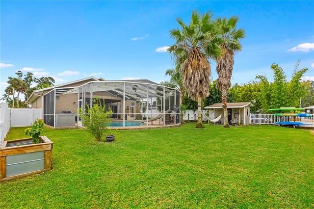 a view of a house with backyard and sitting area