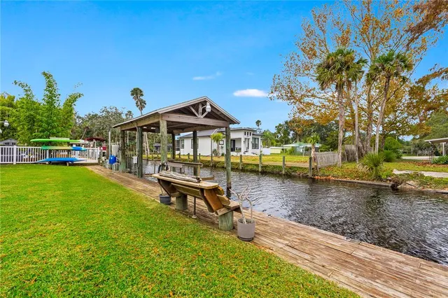 a view of residential houses with outdoor space and lake view