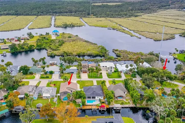 an aerial view of residential houses with outdoor space and swimming pool