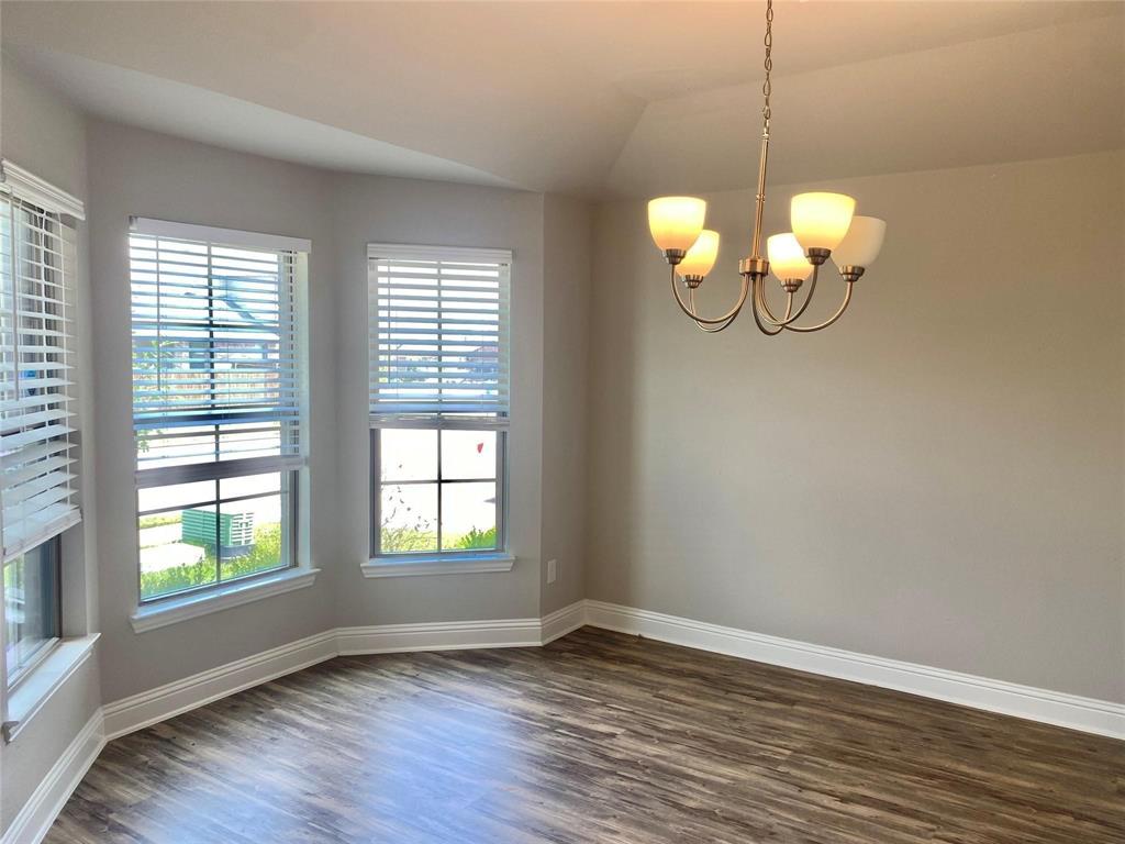 2258 Templin Avenue Forney, TX 75126 - Photo 3 of 15 a view of a room with wooden floor and chandelier