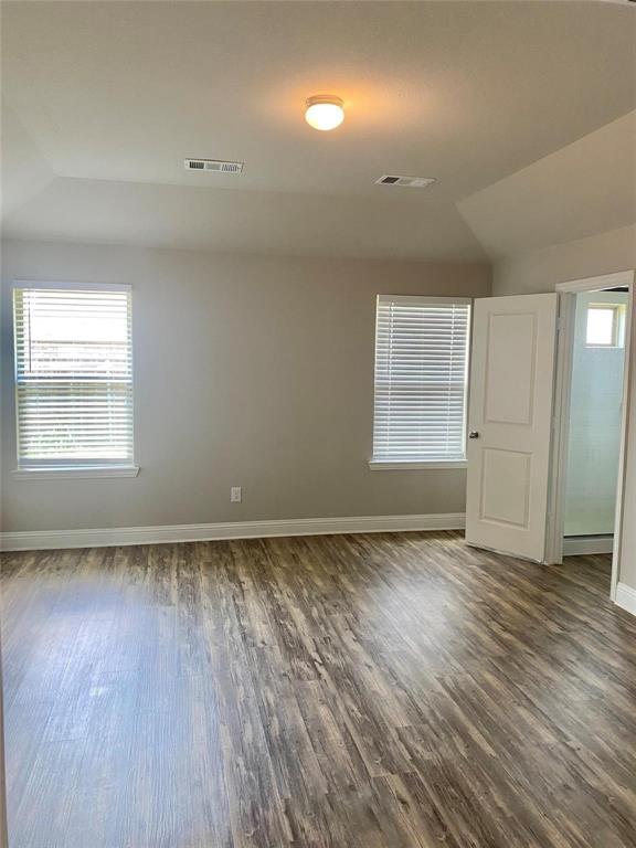 2258 Templin Avenue Forney, TX 75126 - Photo 10 of 15 an empty room with wooden floor and windows