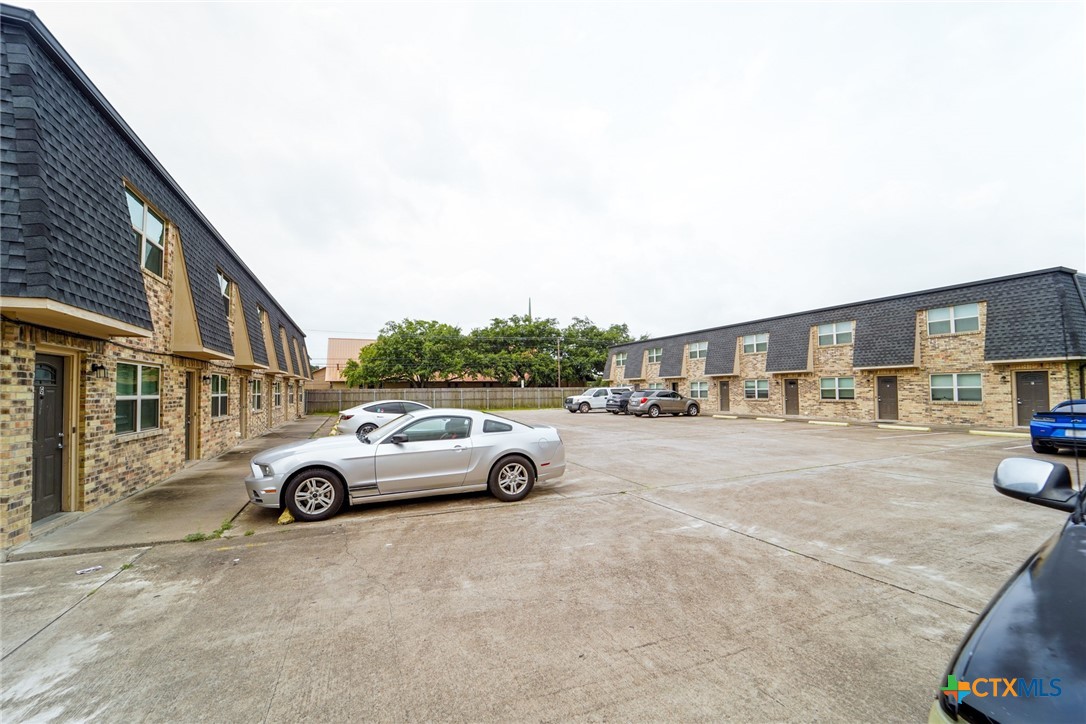 a view of street with parked cars