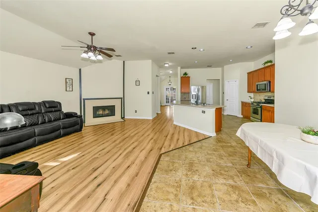 a spacious bedroom with a bed a couch and dresser